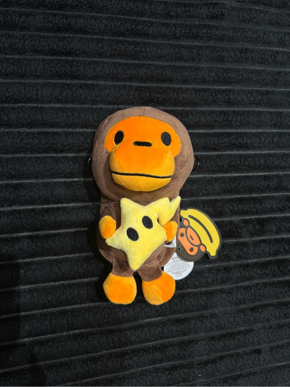 A Bathing Ape (BAPE) Brown & Orange Ape Plush Keychain with Yellow Star